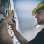 electrician testing-voltage-in-a-fuse-box